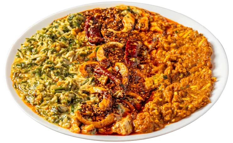 Hum-Tum - egg in green garlic tomato cheese gravy, topped with sesame and chili